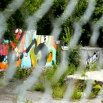 murals through fence - photo by: ryan sterritt