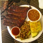 ribs with field peas, baked beans, corn bread, pickle & pineapple wedge - photo by: ryan sterritt